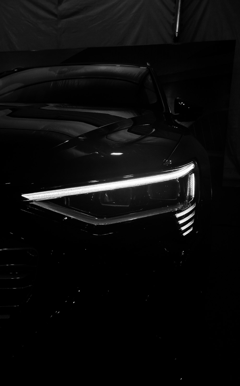 a black sports car is shown in the dark