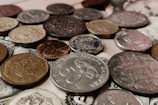 a pile of coins sitting on top of a pile of money