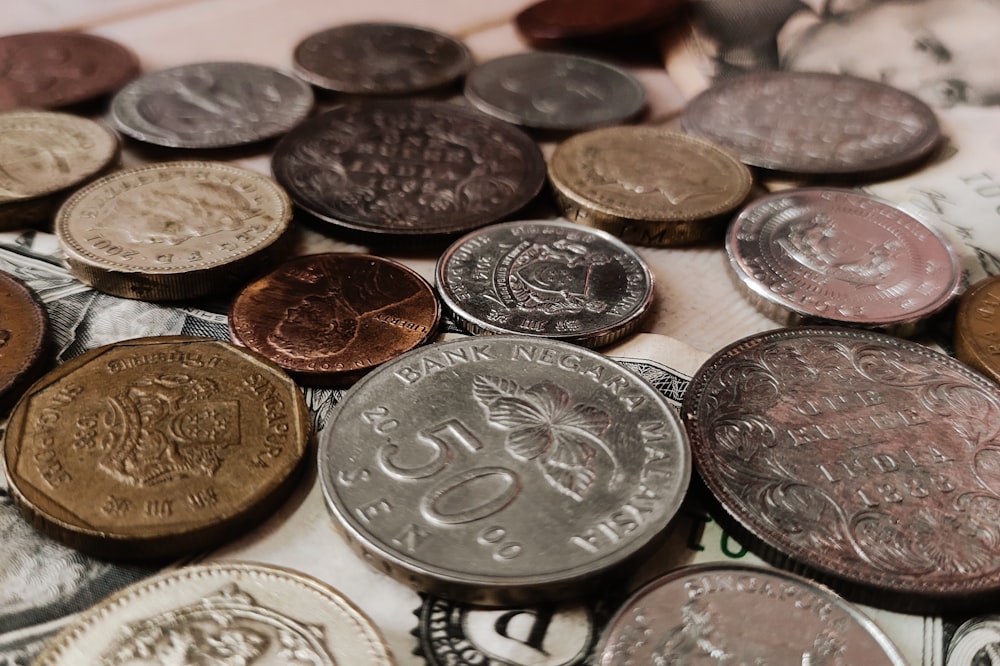 a pile of coins sitting on top of a pile of money