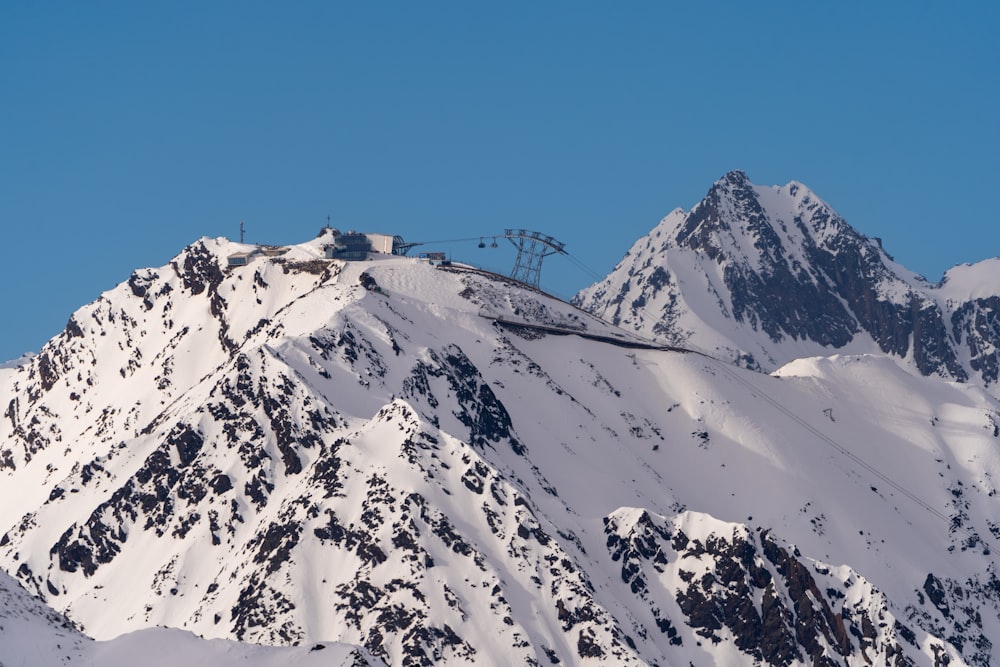 a mountain covered in snow with a ski lift on top of it