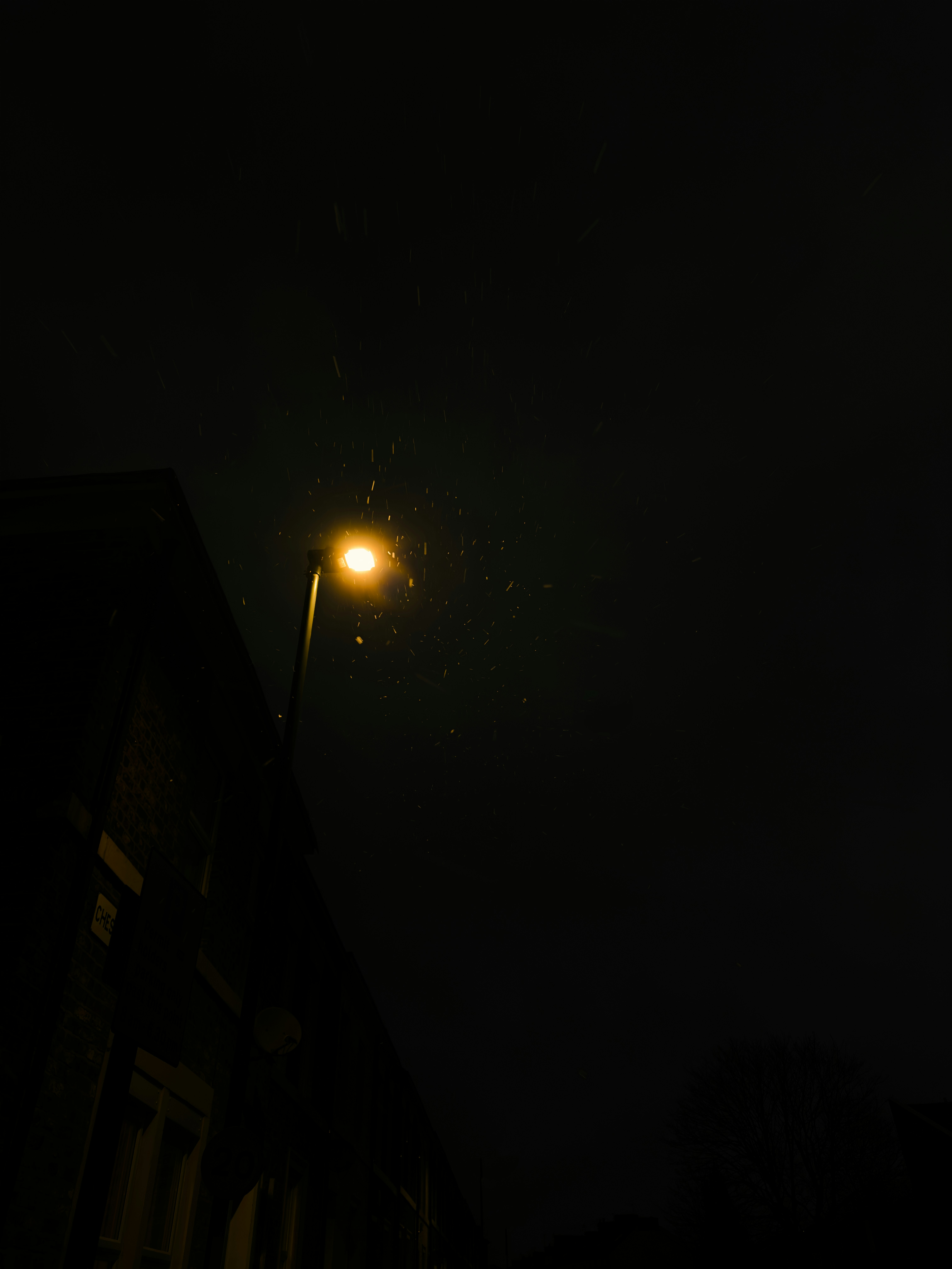 a street light on a dark street at night