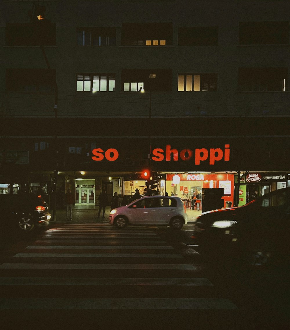 a car driving down a street at night