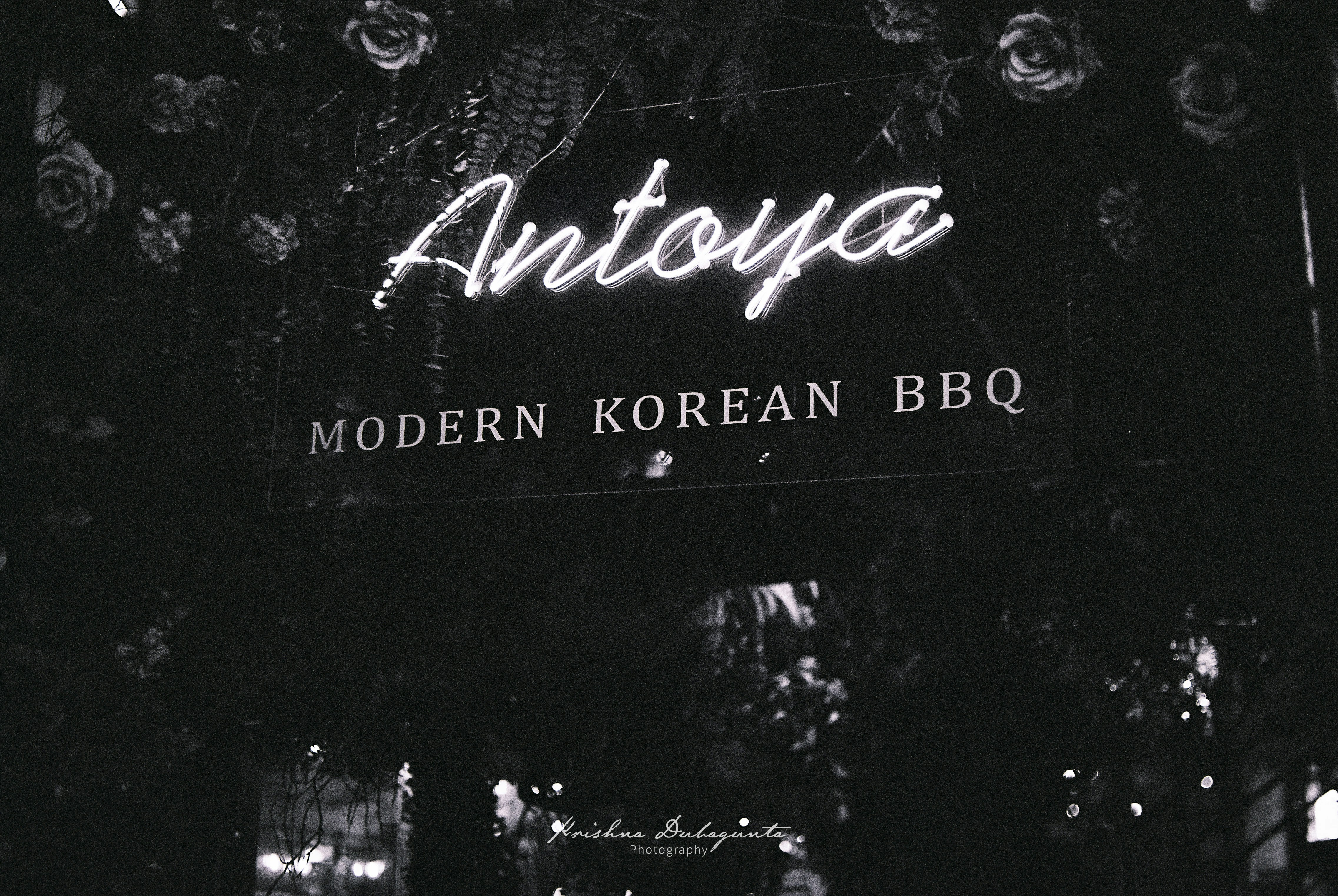 a black and white photo of a neon sign, 