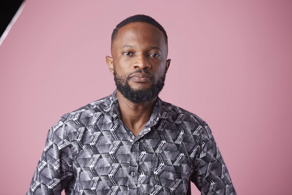 a man with a beard and a patterned shirt