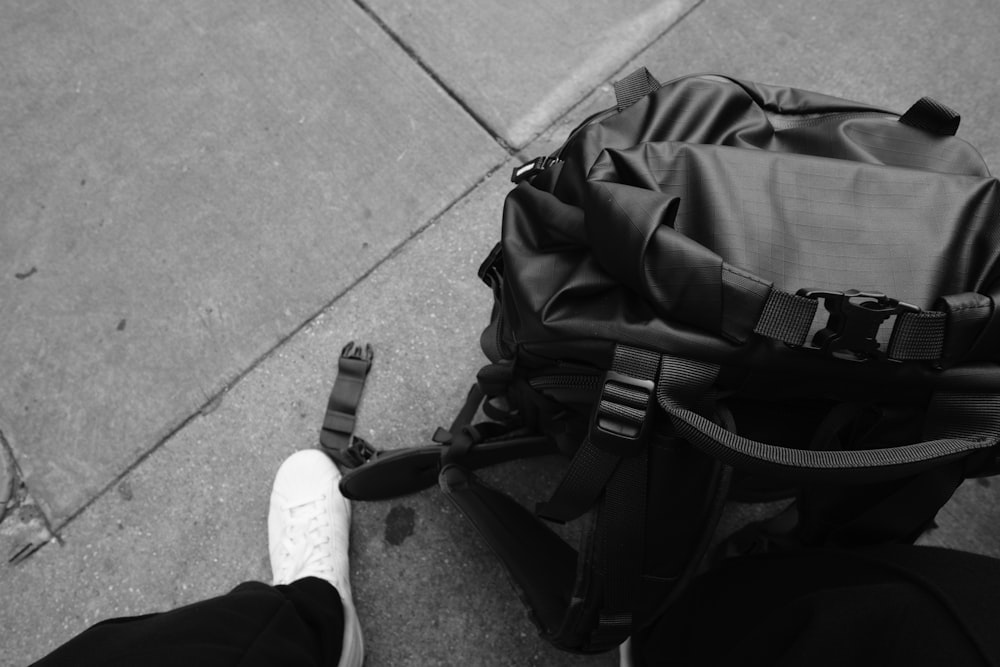 a black and white photo of a person with a backpack