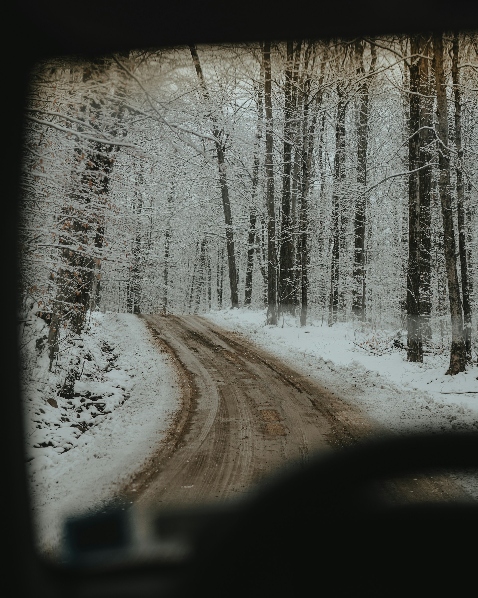 a car driving down a snow covered road