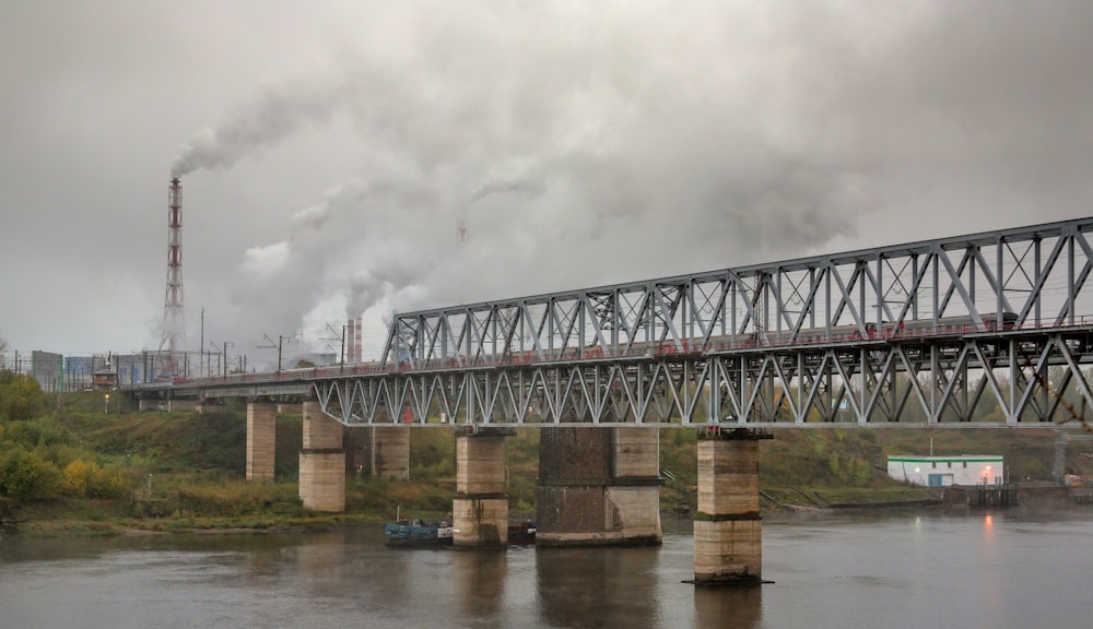 a train traveling over a bridge over a river