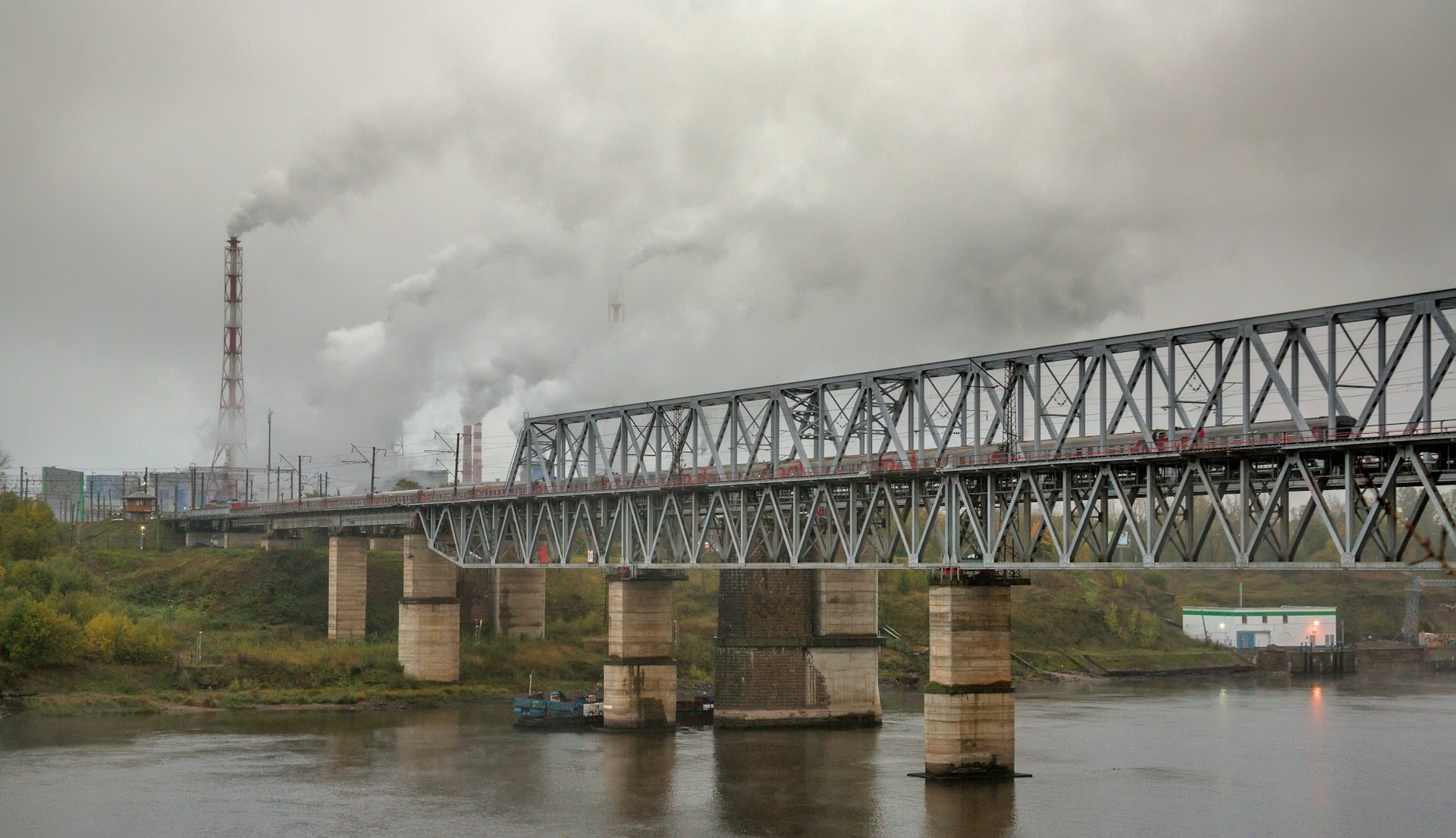 a train traveling over a bridge over a river