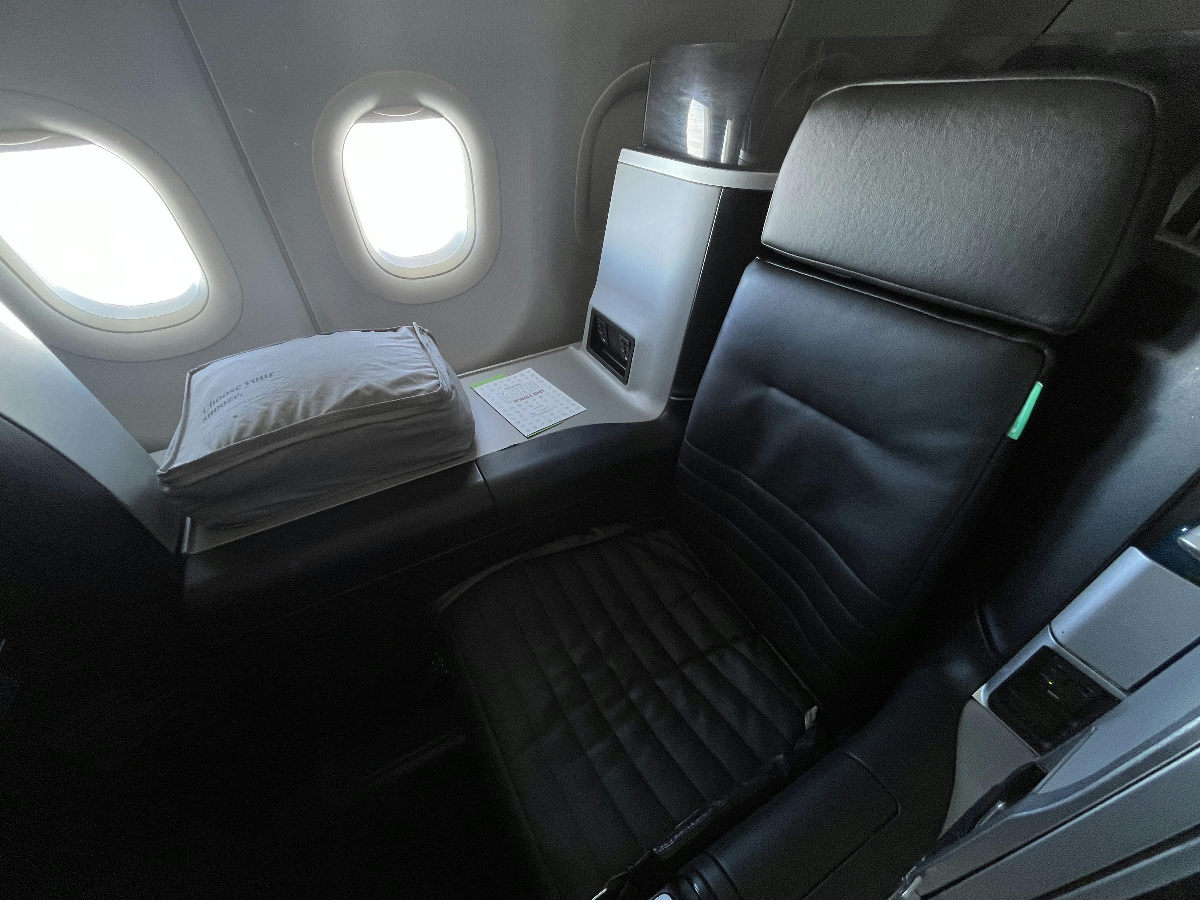 a seat in an airplane with the windows open, JetBlue Mint business class seat.