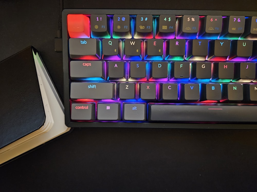 a keyboard and a book on a table