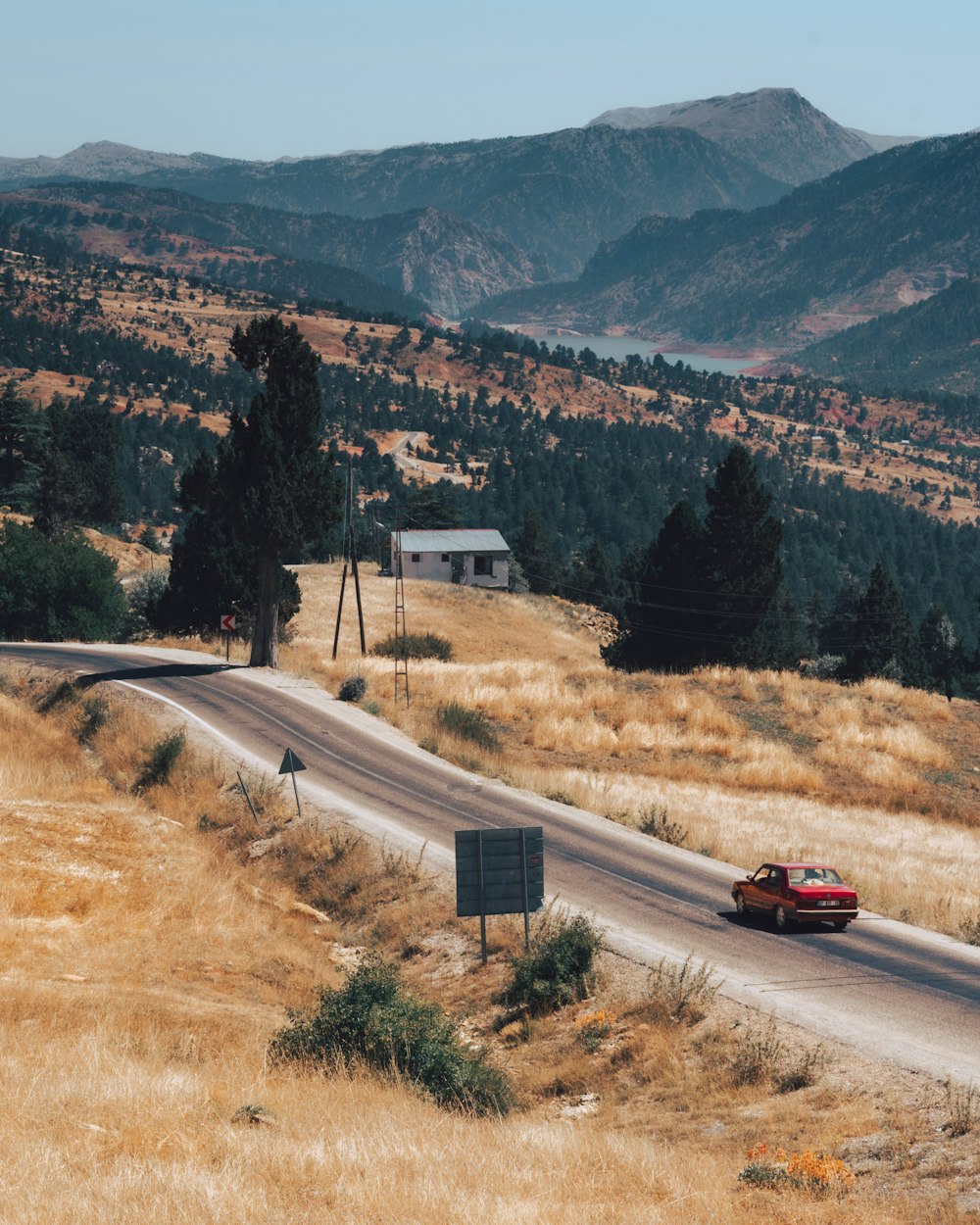 a car driving down a road in the mountains