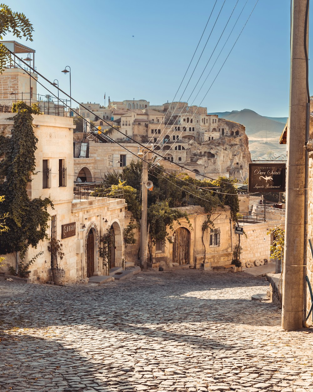 a cobblestone street with buildings in the background