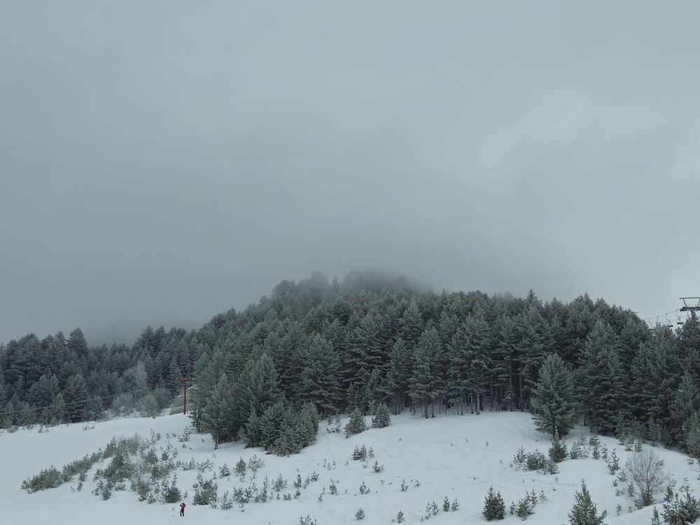 a snow covered mountain with a ski lift in the distance