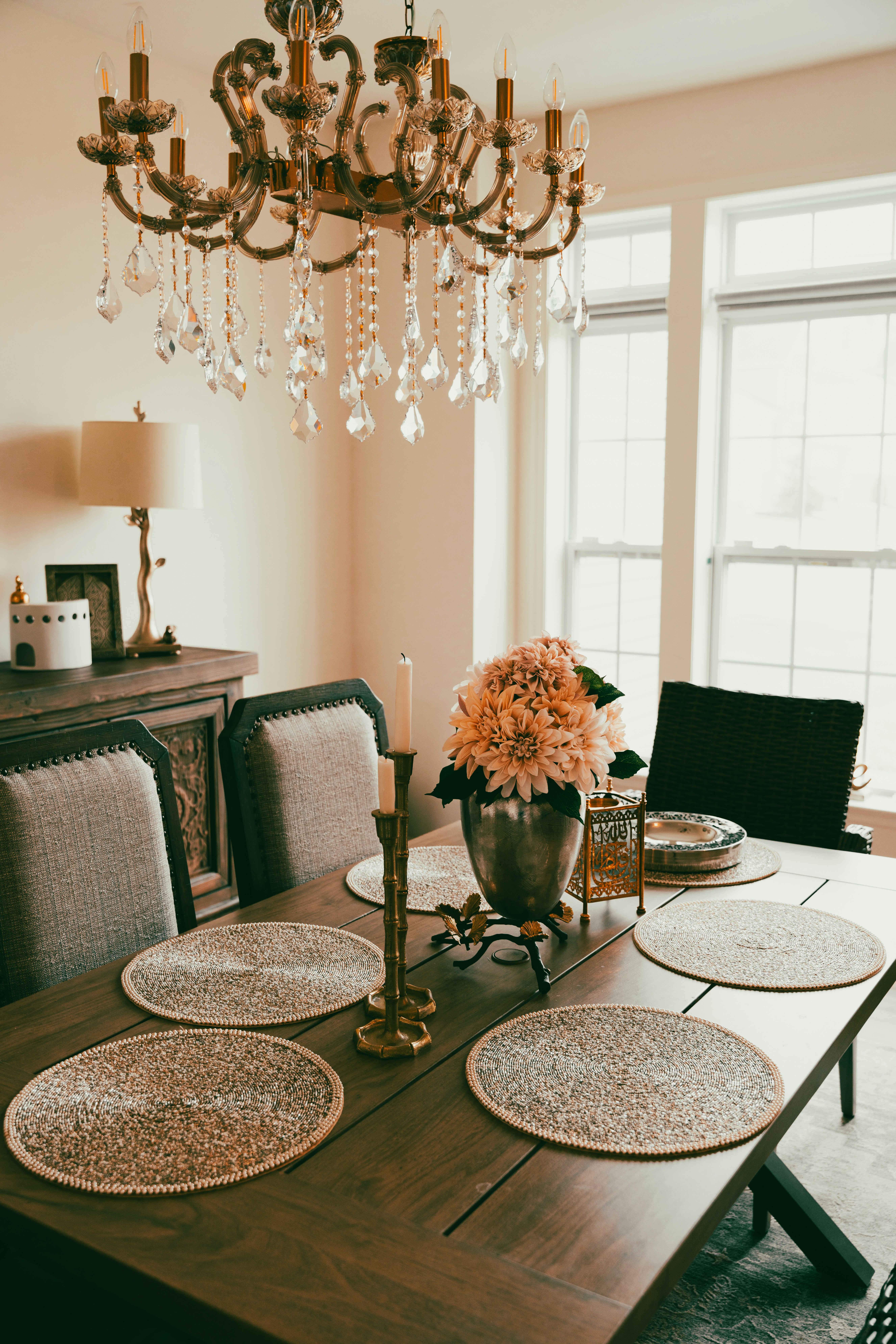 a chandelier hangs over a dining room table