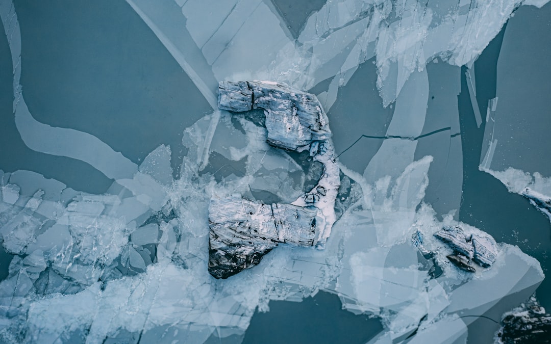 A topdown view of an iceberg floating in icey waters, New Zealand