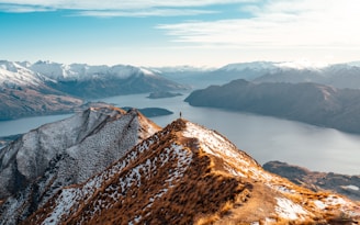a view of a mountain range with a lake in the distance
