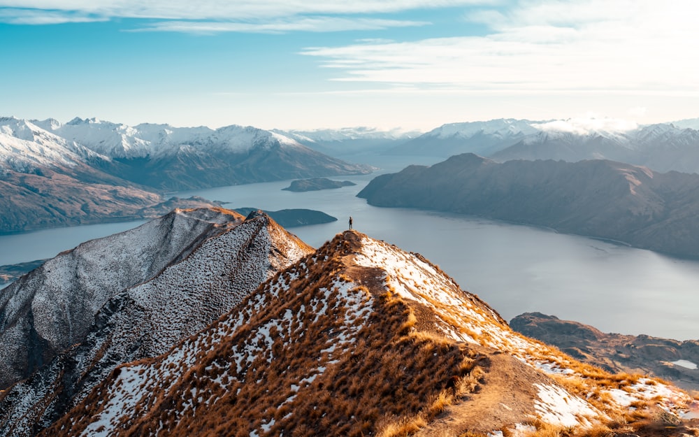 a view of a mountain range with a lake in the distance