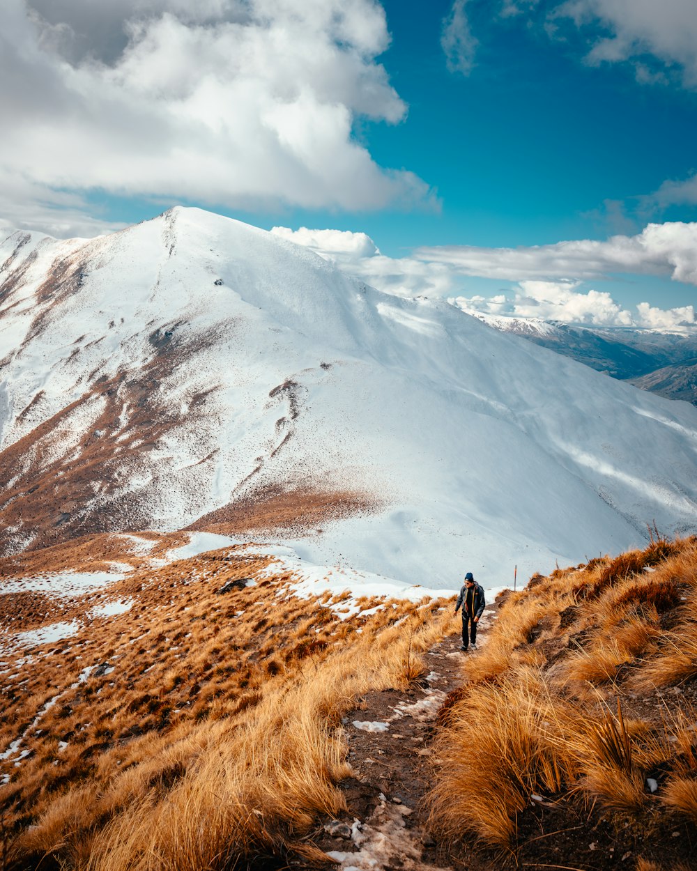 a man walking up a snow covered mountain