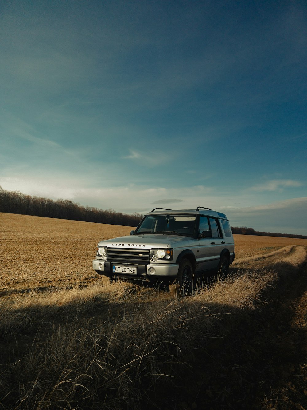 a land rover is parked in a field