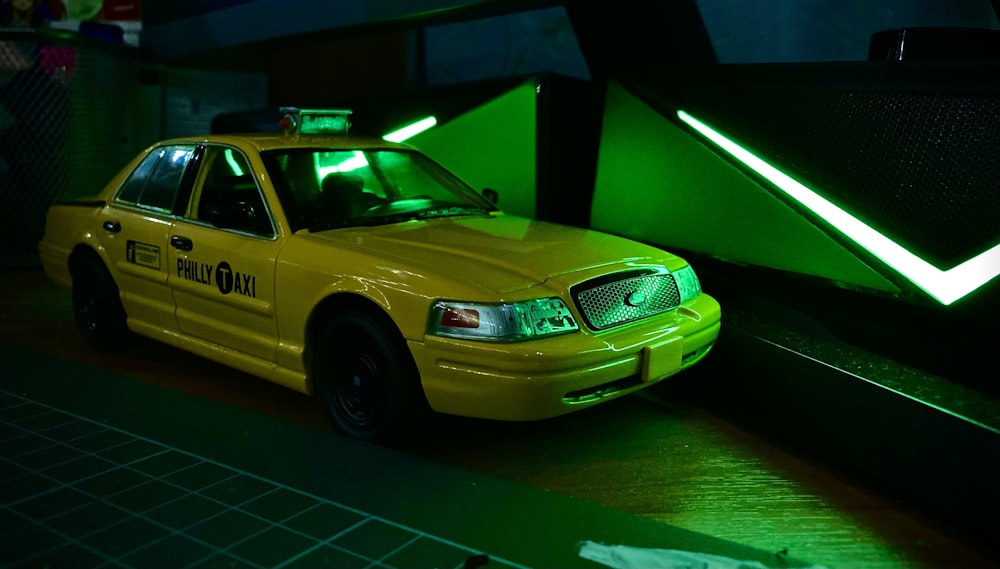 a taxi cab parked in front of a green light