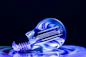 a blue light bulb sitting on top of a table