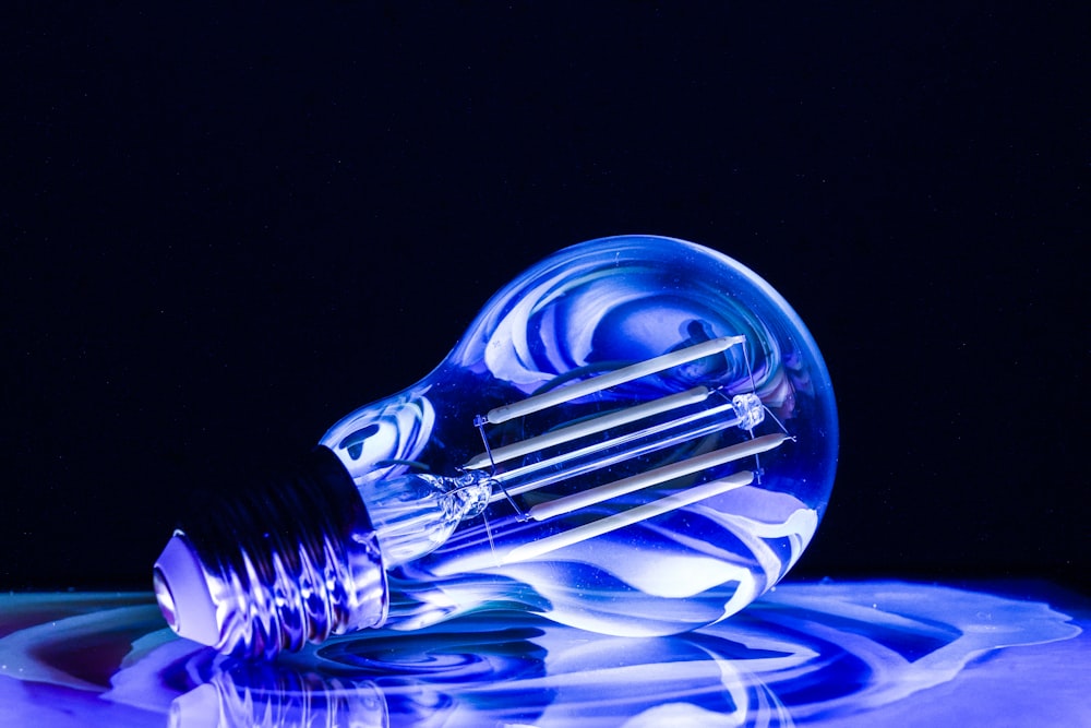 a blue light bulb sitting on top of a table
