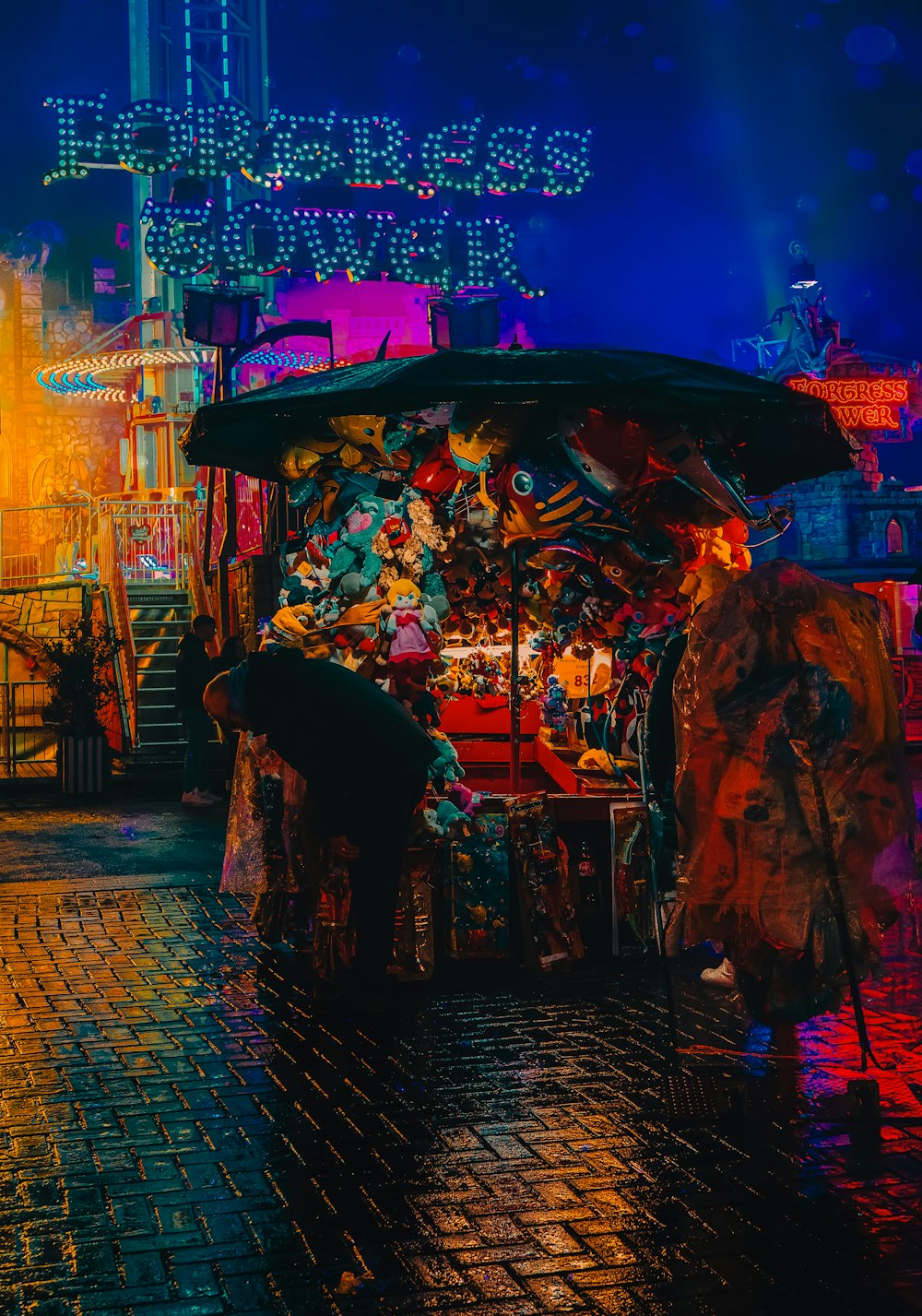 a street vendor stands under an umbrella in the rain