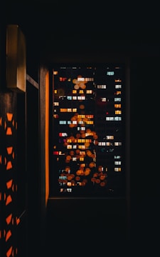 a window with a view of a city at night