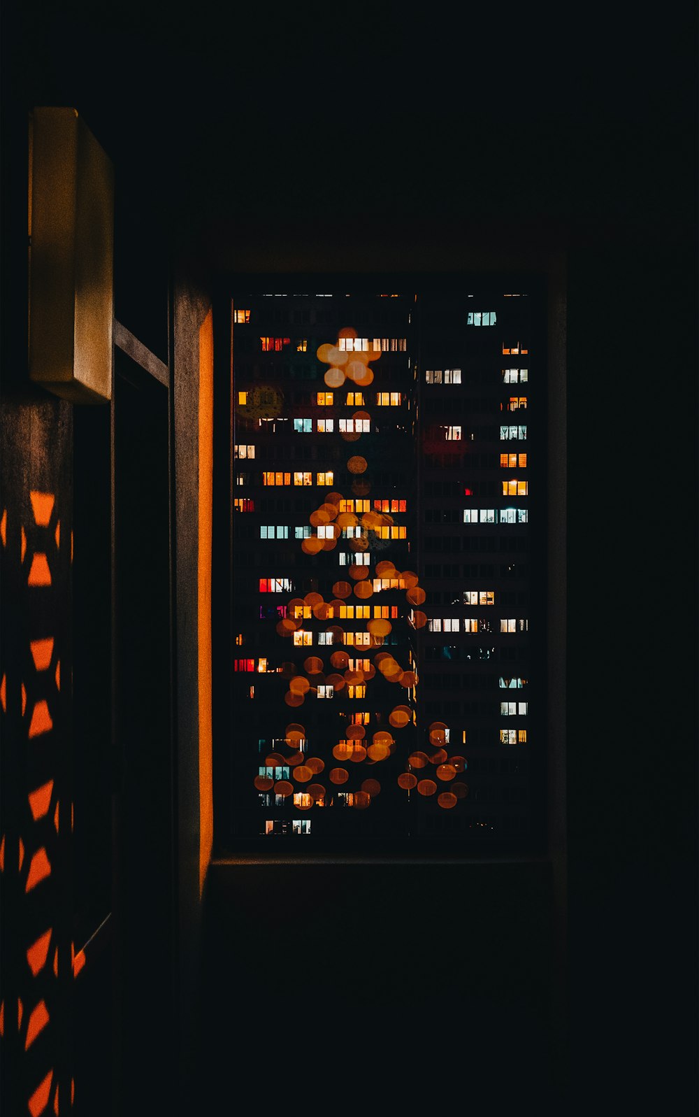 a window with a view of a city at night