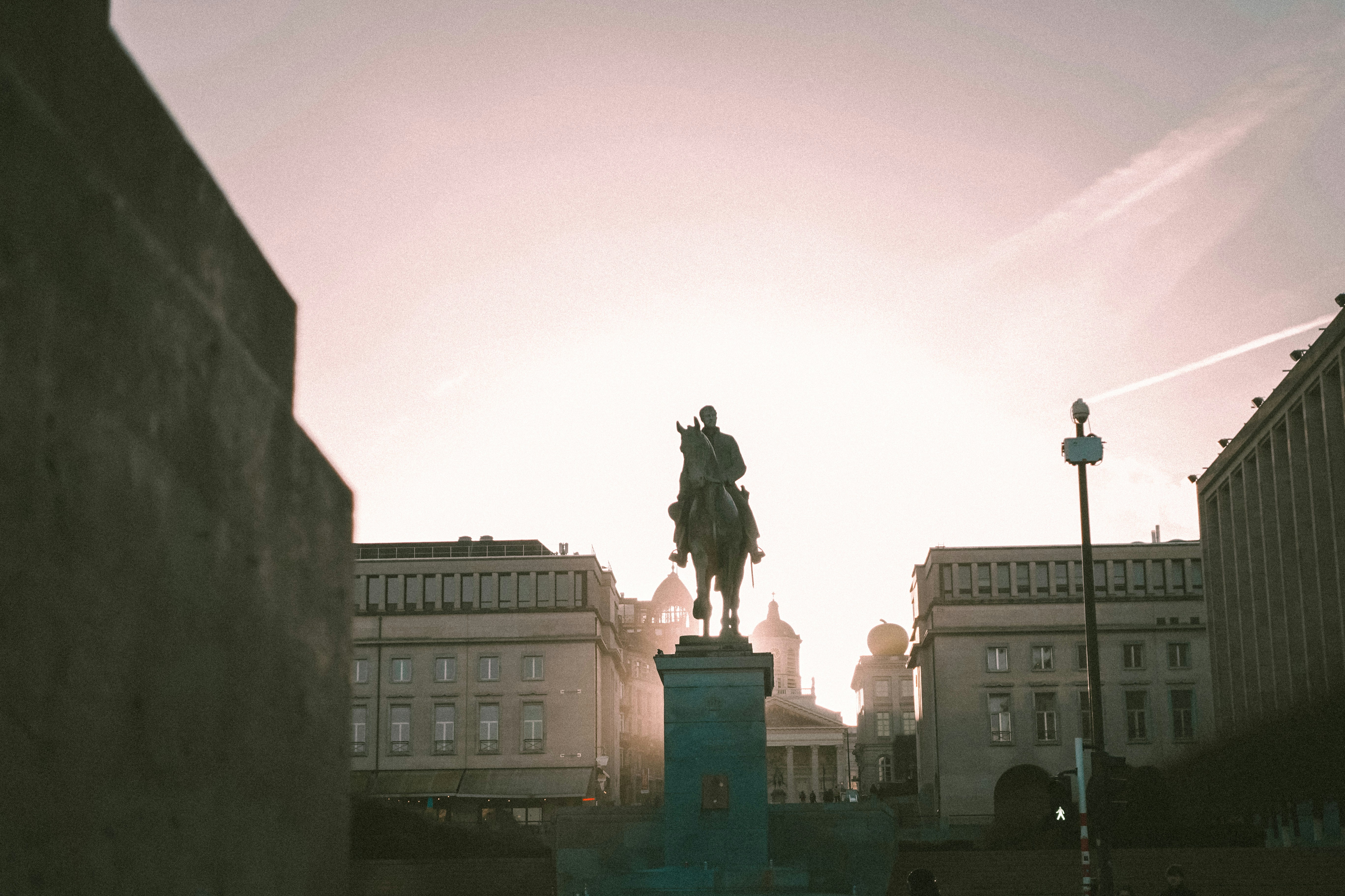 a statue of a man on a horse in a city, 