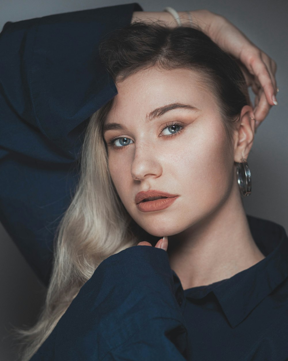 a woman with blonde hair wearing a blue shirt