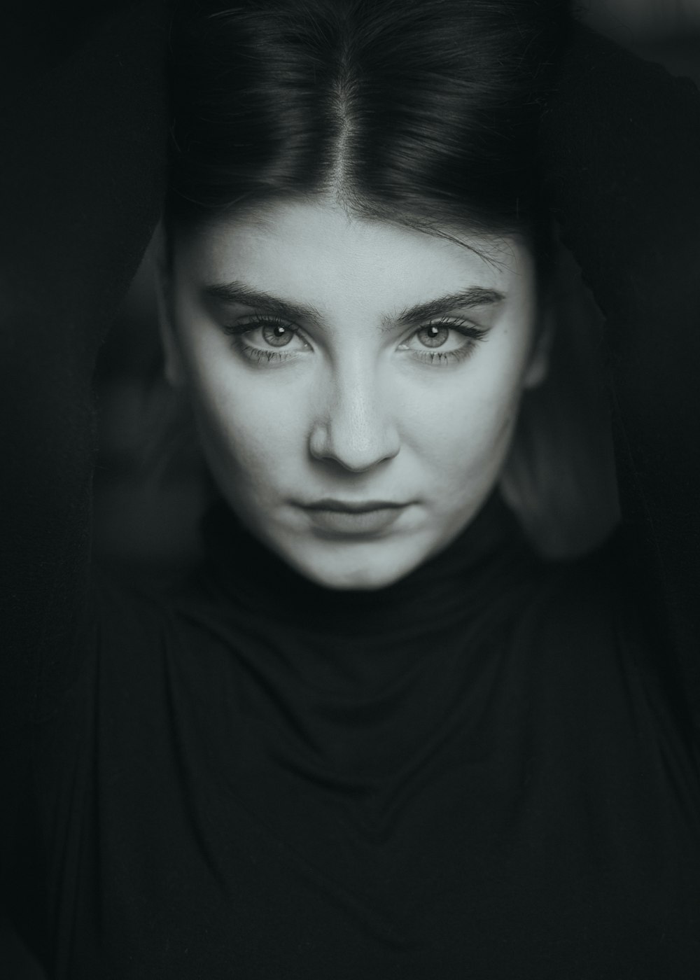 a black and white photo of a woman with blue eyes