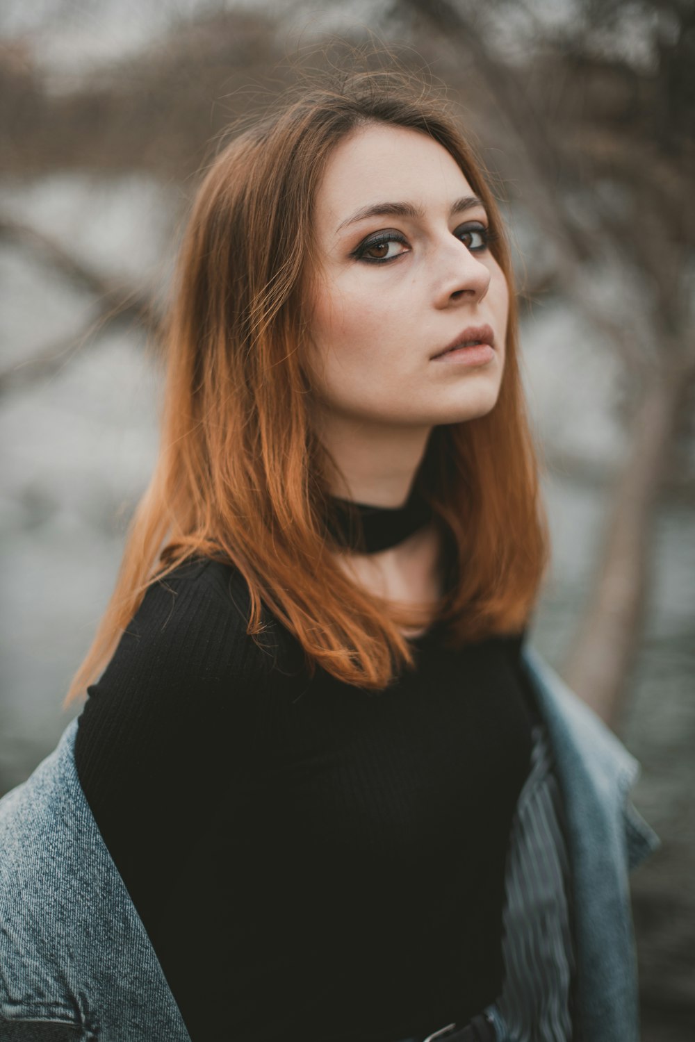 a woman with red hair and a black shirt