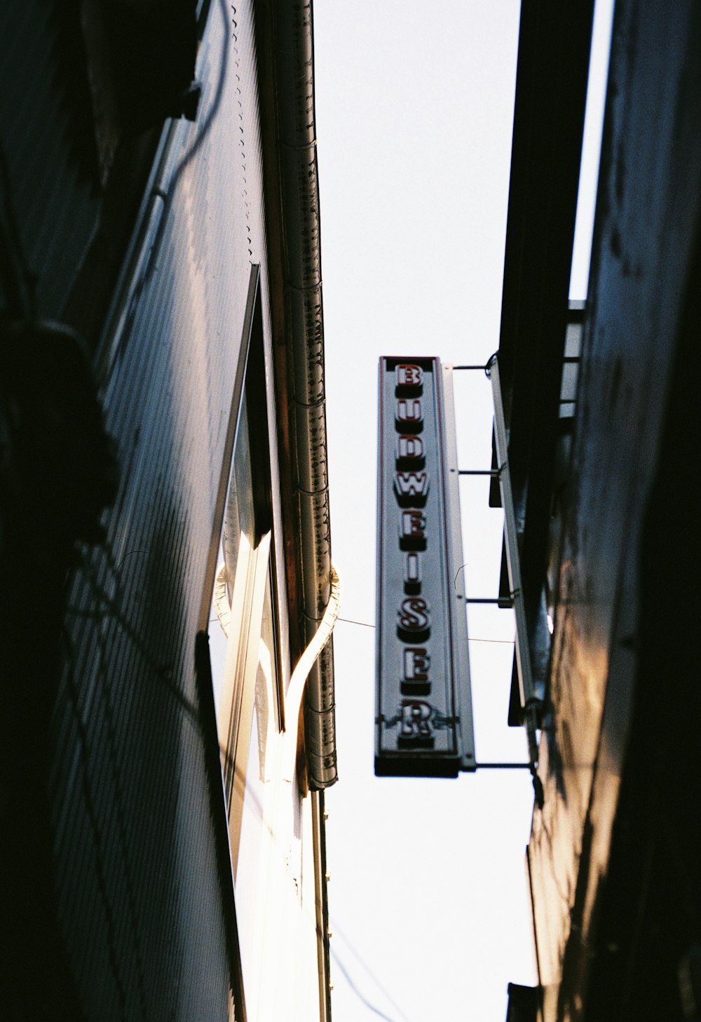 a sign hanging from the side of a building