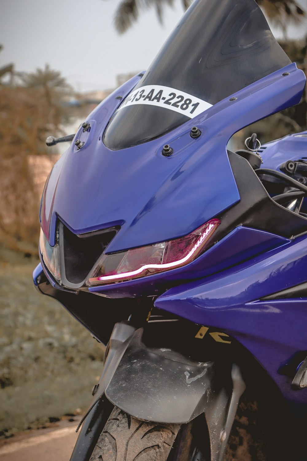 a close up of a motorcycle parked on the side of a road