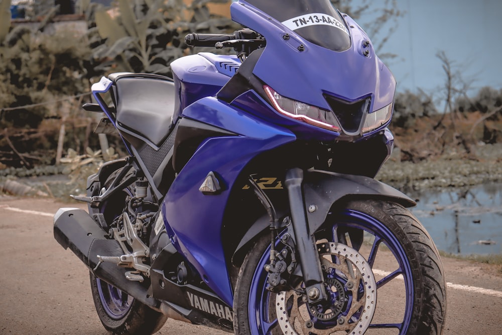 a blue motorcycle parked on the side of the road