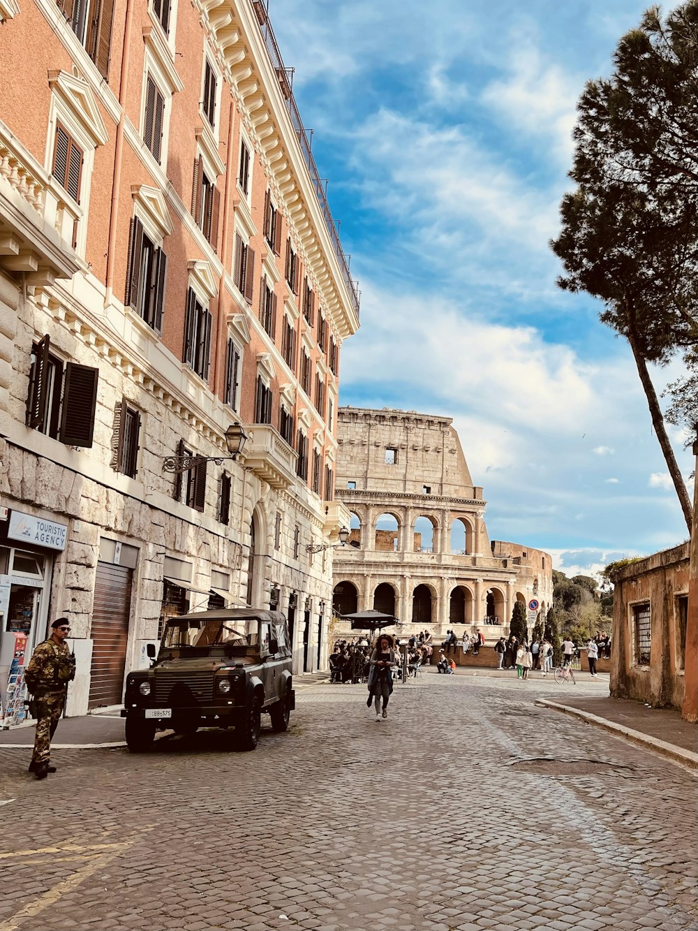 an old car is parked on a cobblestone street