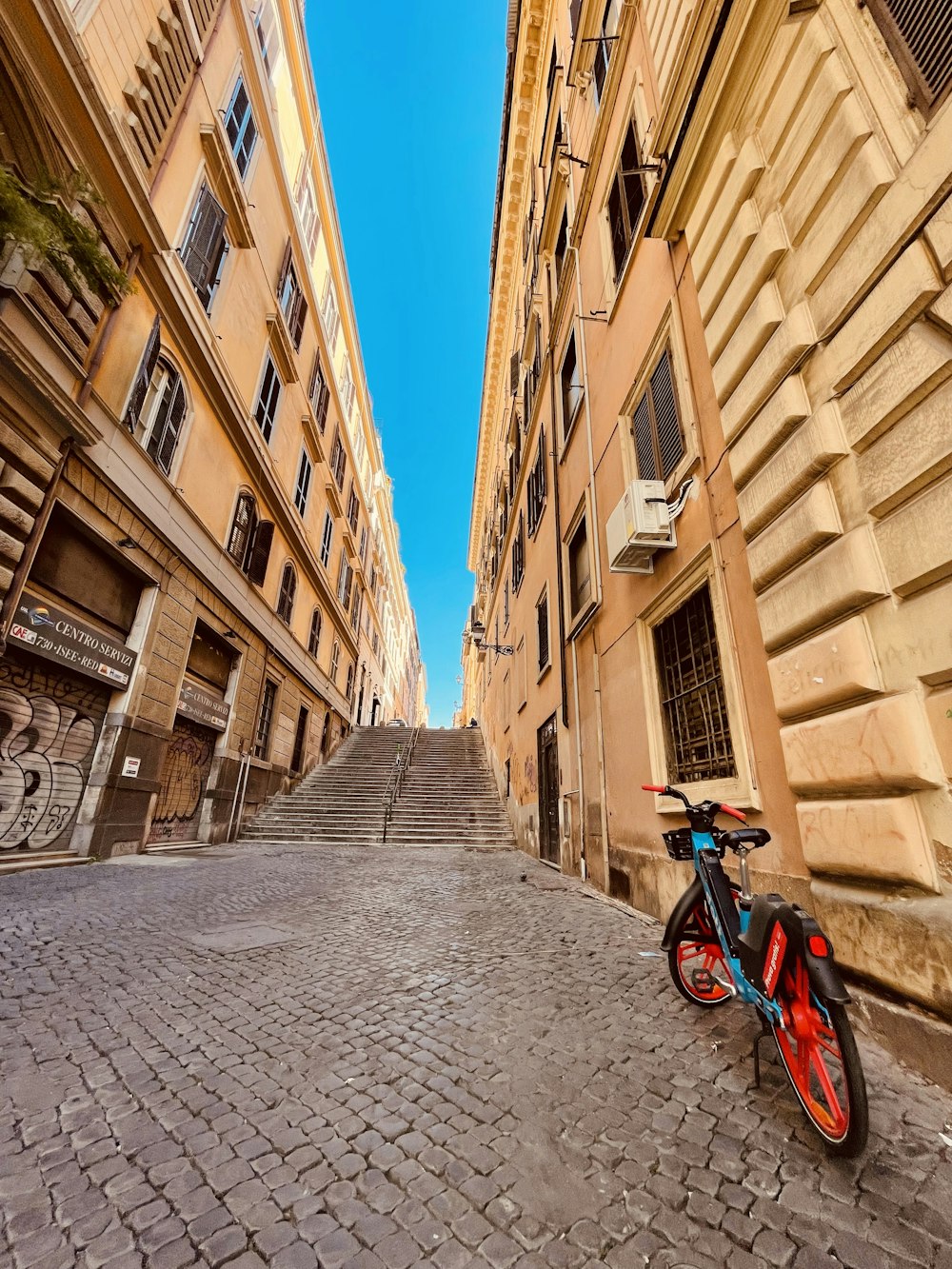 a bike is parked on a cobblestone street