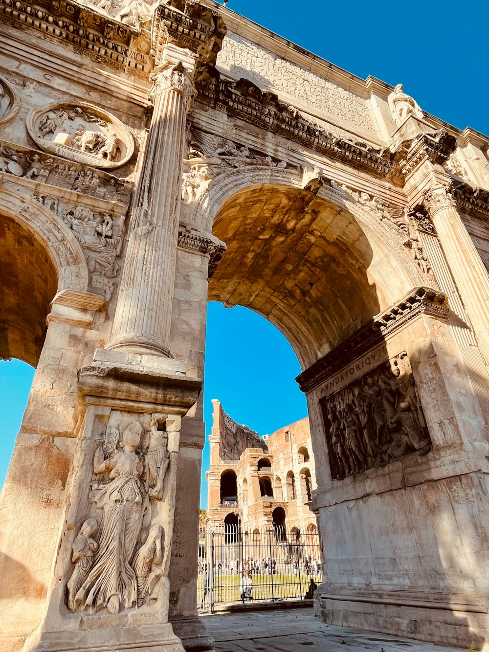 a large stone arch with statues on it