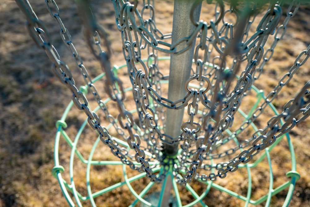 a close up of a metal object with chains on it