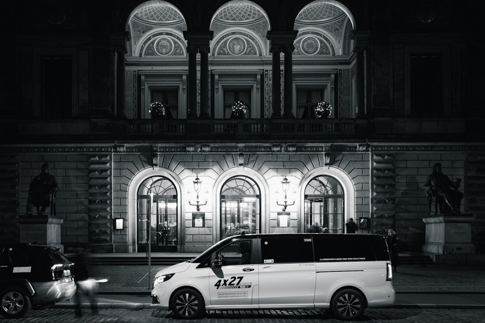 a white van parked in front of a building