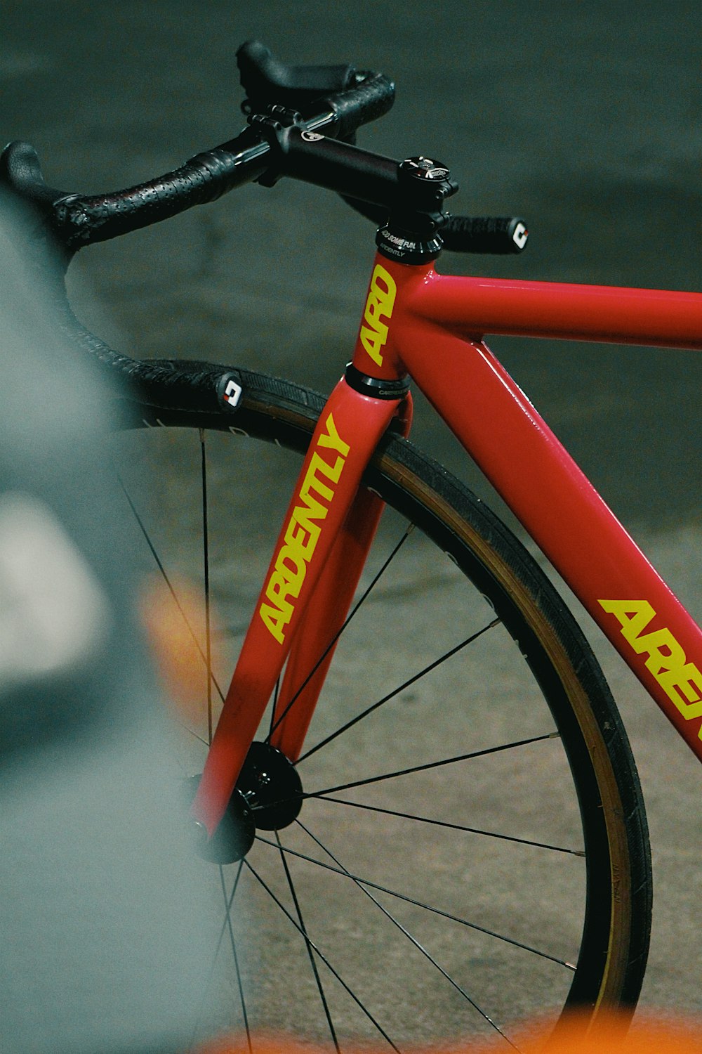 a close up of a red bike on a street