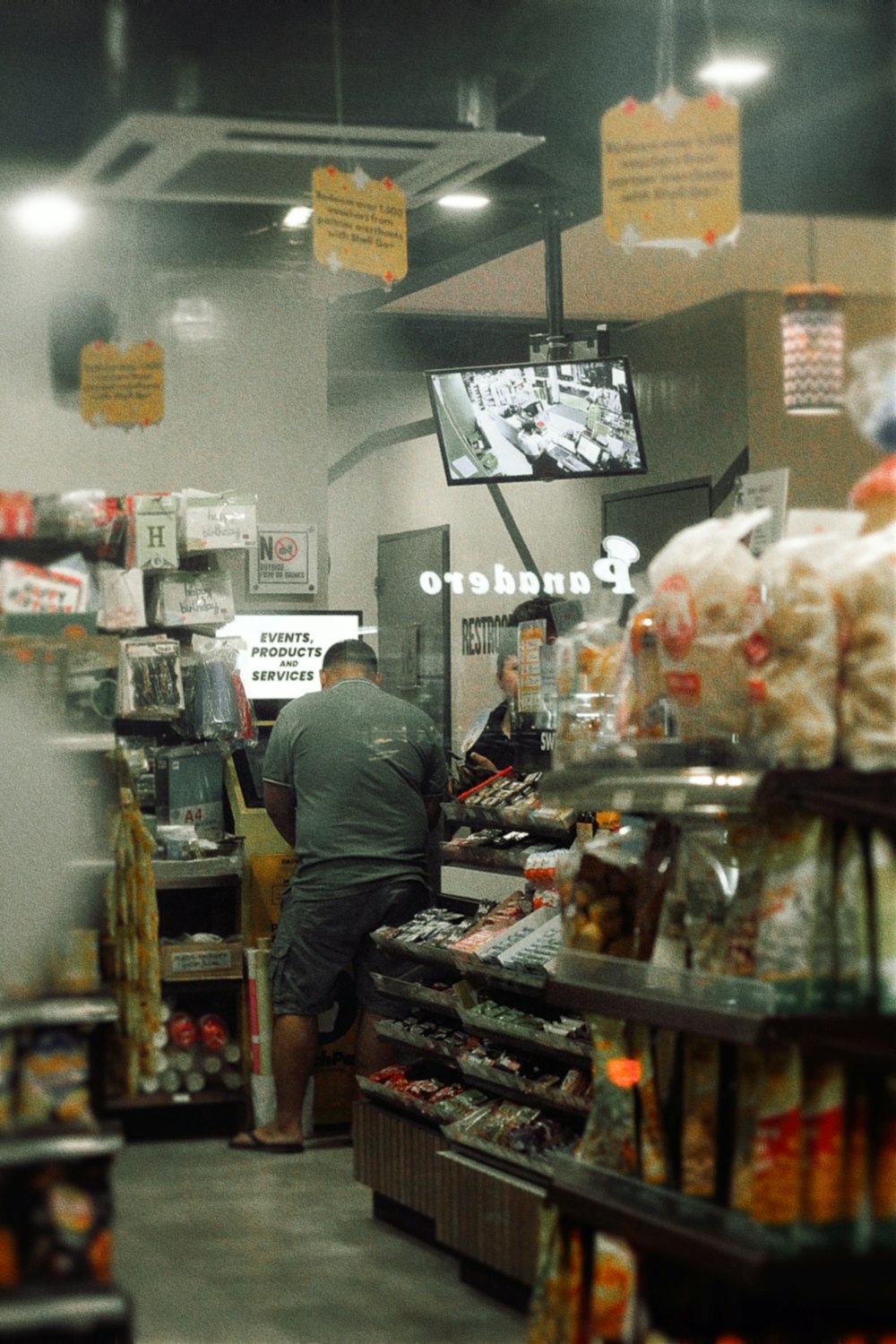 a man standing in a store filled with food