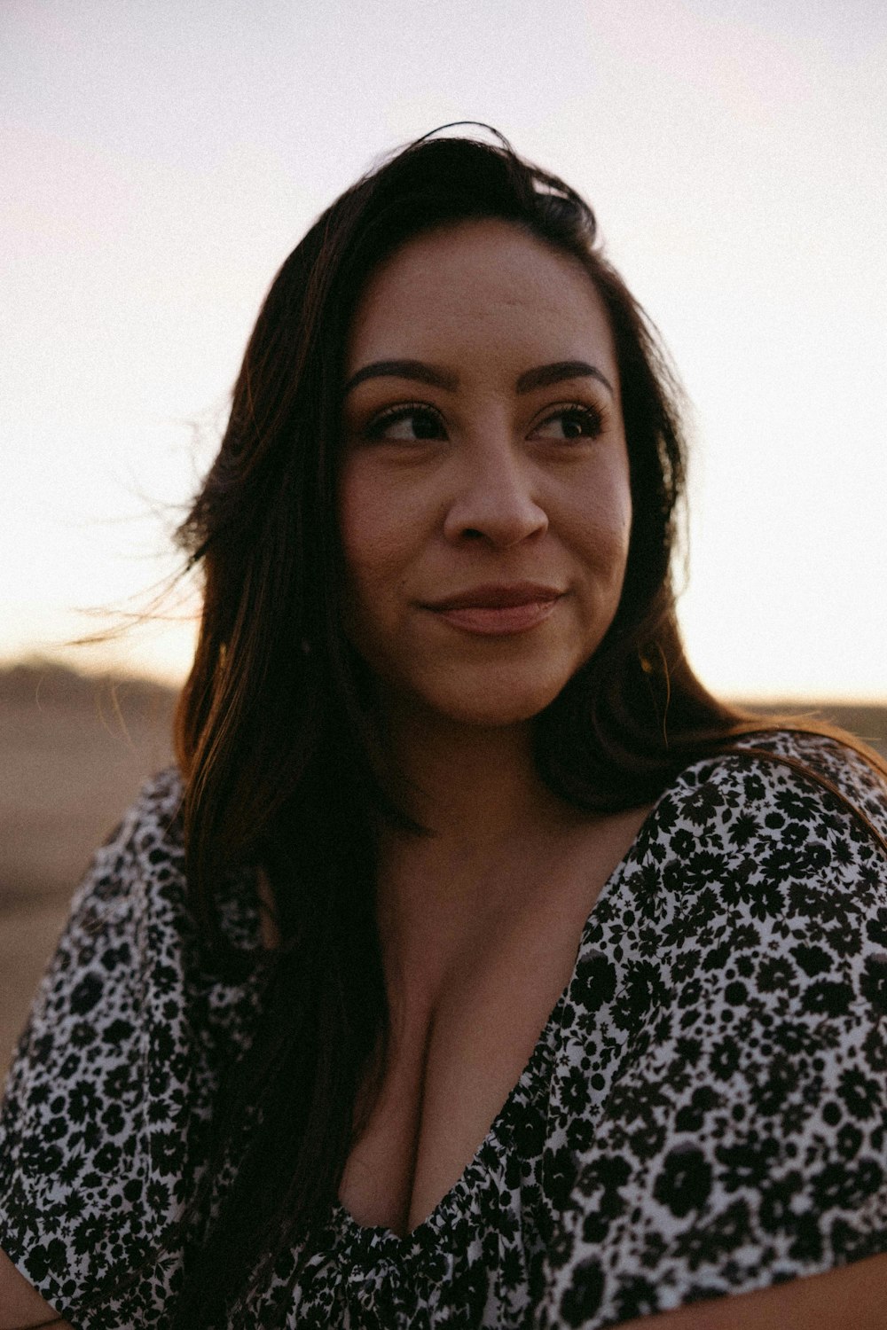 a woman in a black and white dress posing for a picture