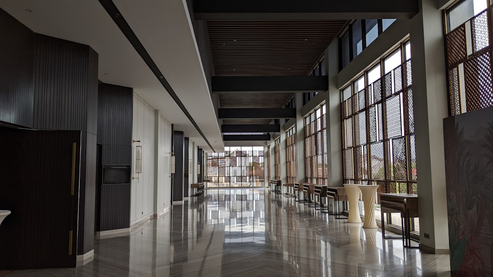 a long hallway with lots of windows and benches