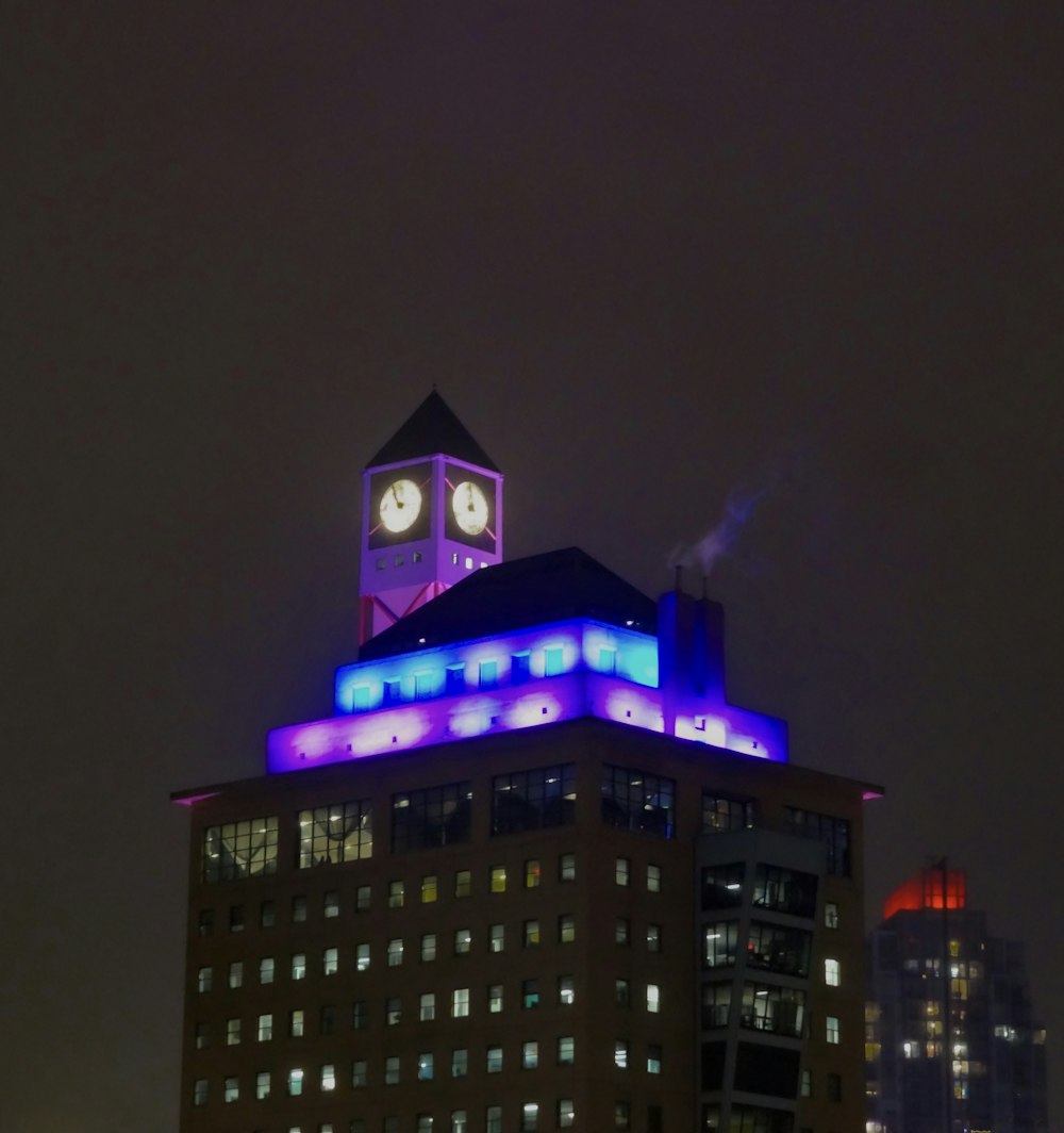 a building with a clock tower lit up at night