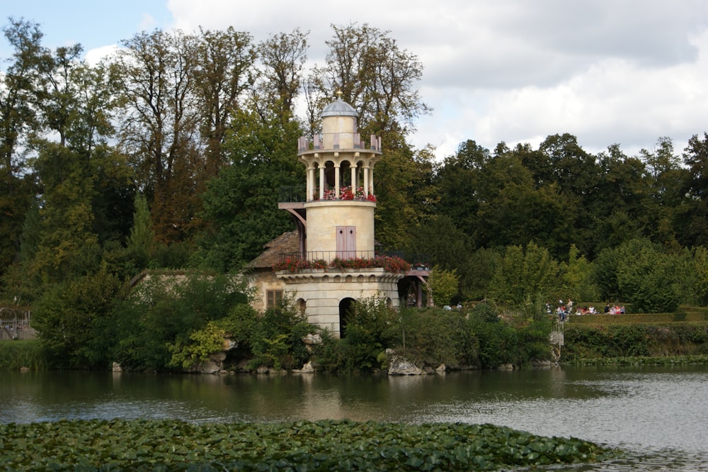 a building with a tower near a body of water