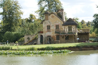 Hamlet Versailles a house with a pond in front of it