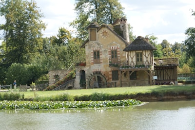 Hamlet Versailles a house with a pond in front of it