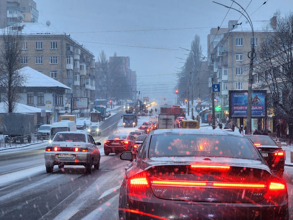 a city street filled with lots of traffic on a snowy day